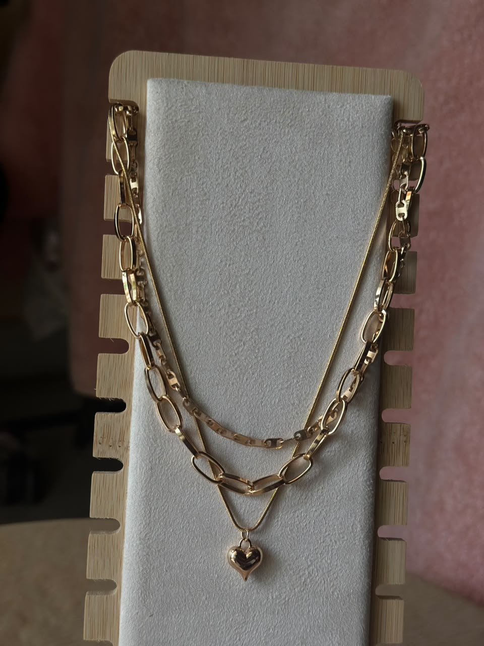 Close-up of golden heart layered chain necklace