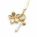 Gold Blossom & Pearl Bracelet charm detail close-up — flower, pearl, and star charms