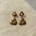 Twisted Knot Drop Earrings on cream linen flat lay — anti-tarnish gold drop earrings India — SIOBHÁN
