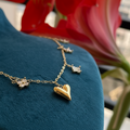 Floral Heart Charm Necklace extreme close-up heart and flower charms — anti-tarnish gold necklace India — SIOBHÁN