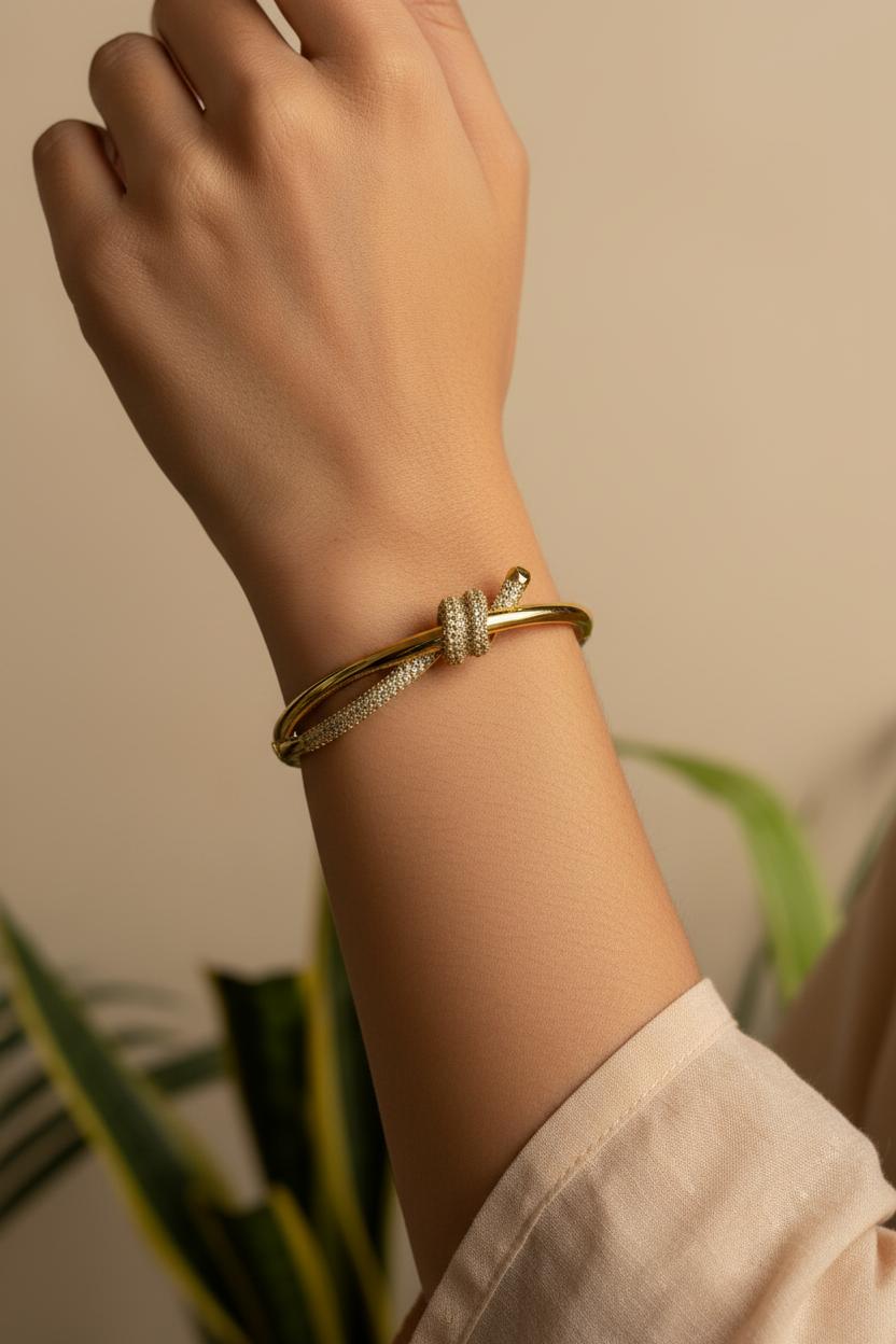 Pavé Knot Bangle — on wrist, warm light
