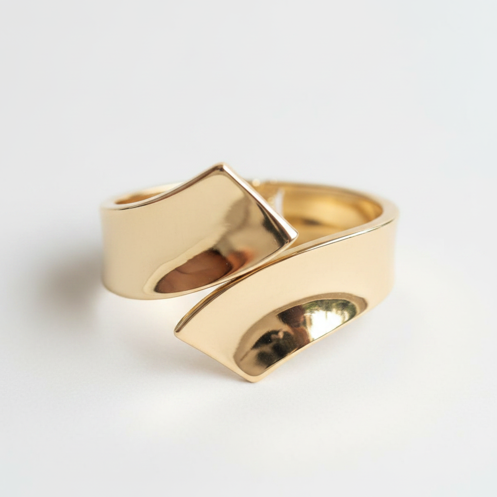 Gold wrap bypass cuff bangle on white background