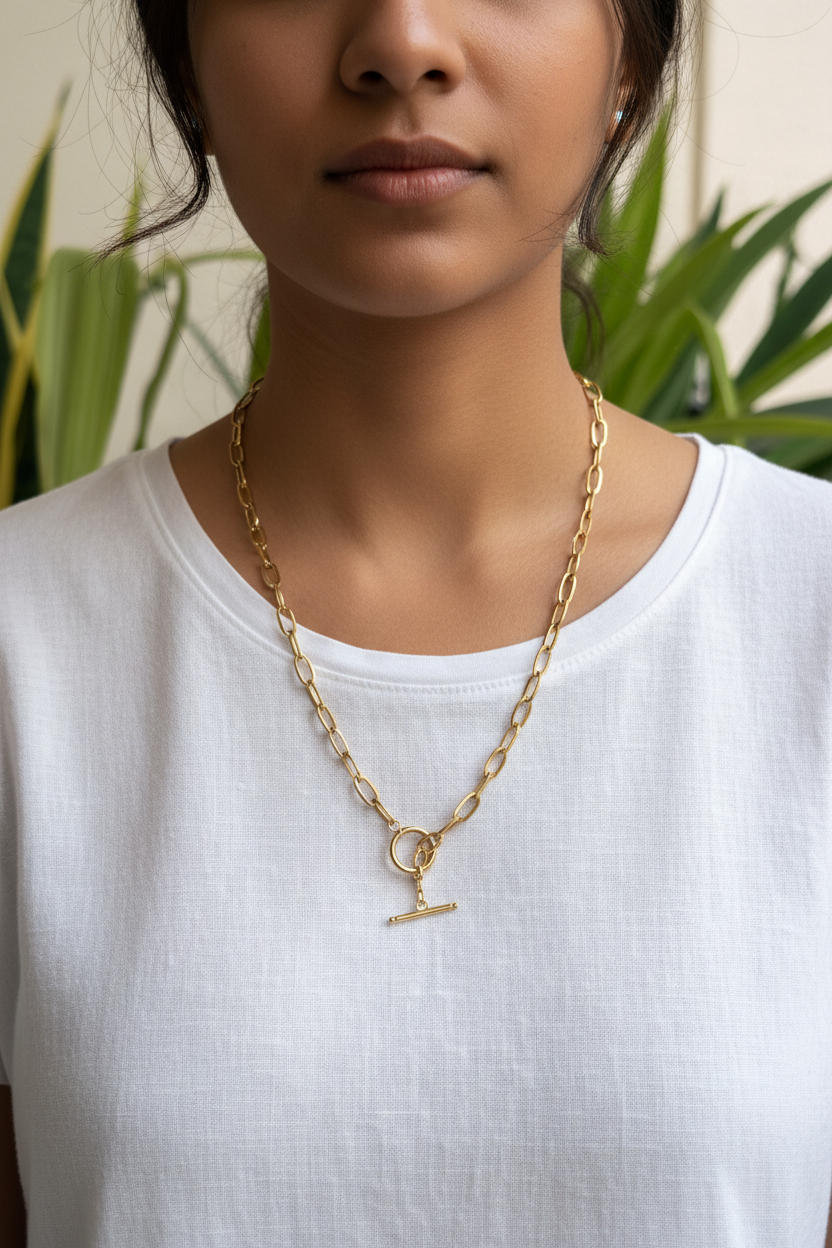 Gold paperclip chain necklace worn by young Indian woman