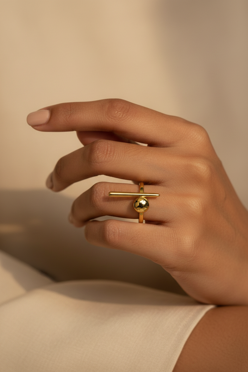Gold Dome Bar Ring — on finger, warm light