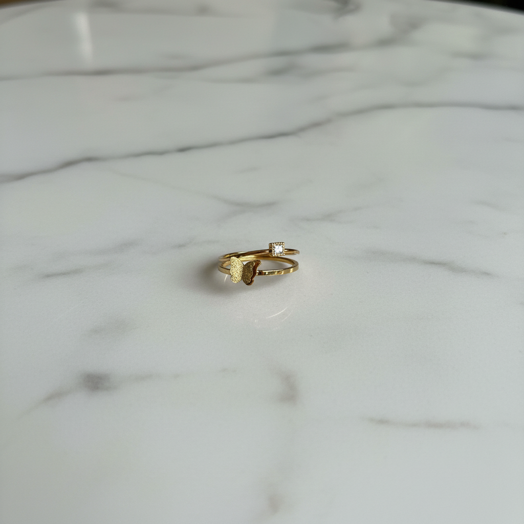 Gold Double-Band Butterfly & CZ Ring — marble flat lay