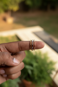 Tri-Tone Solitaire Triple Band Ring — on finger, golden hour