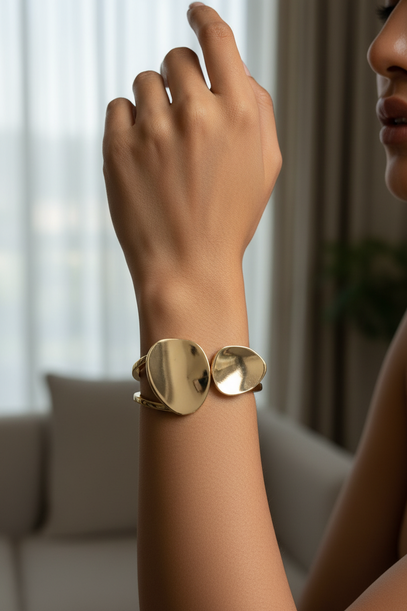 Gold double disc open cuff bangle worn on Indian woman's wrist