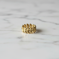 Gold Olive Leaf Wreath Band Ring — marble flat lay