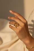 Sculptural Open Heart Ring — on finger, warm light