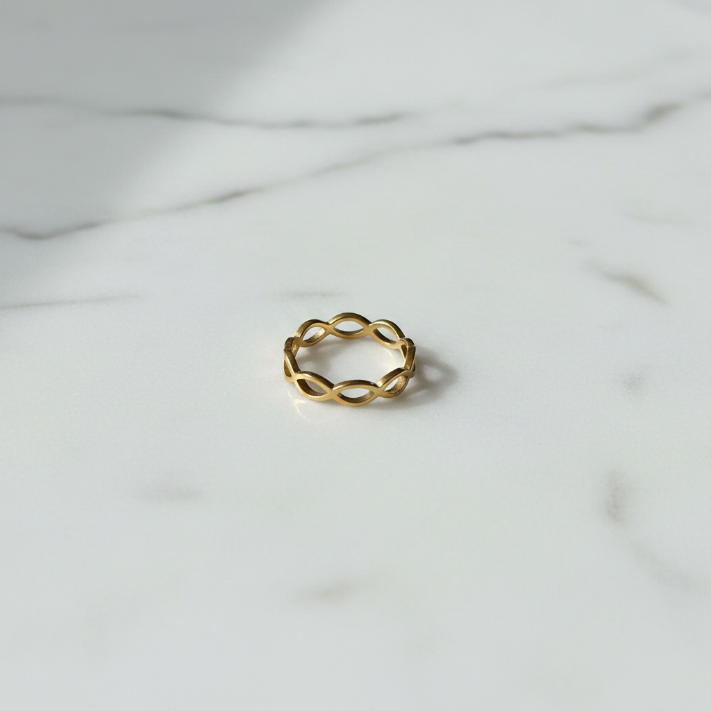 Gold Infinity Weave Band Ring — marble flat lay