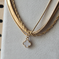 Closeup macro shot - gold clover charm necklace detail
