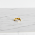 Gold Pavé Channel Eternity Band Ring — marble flat lay