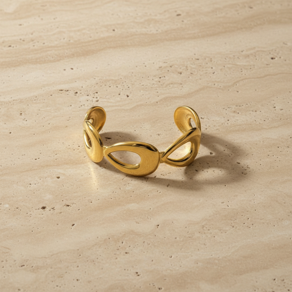 Molten Loop Cuff on travertine surface — anti-tarnish sculptural gold cuff India — SIOBHÁN